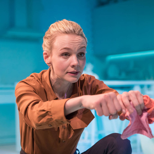 Close-up of actress squeezing cloth in London theatre. 